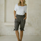 woman wearing a dark grey peace out shorts with wide smocked waistband