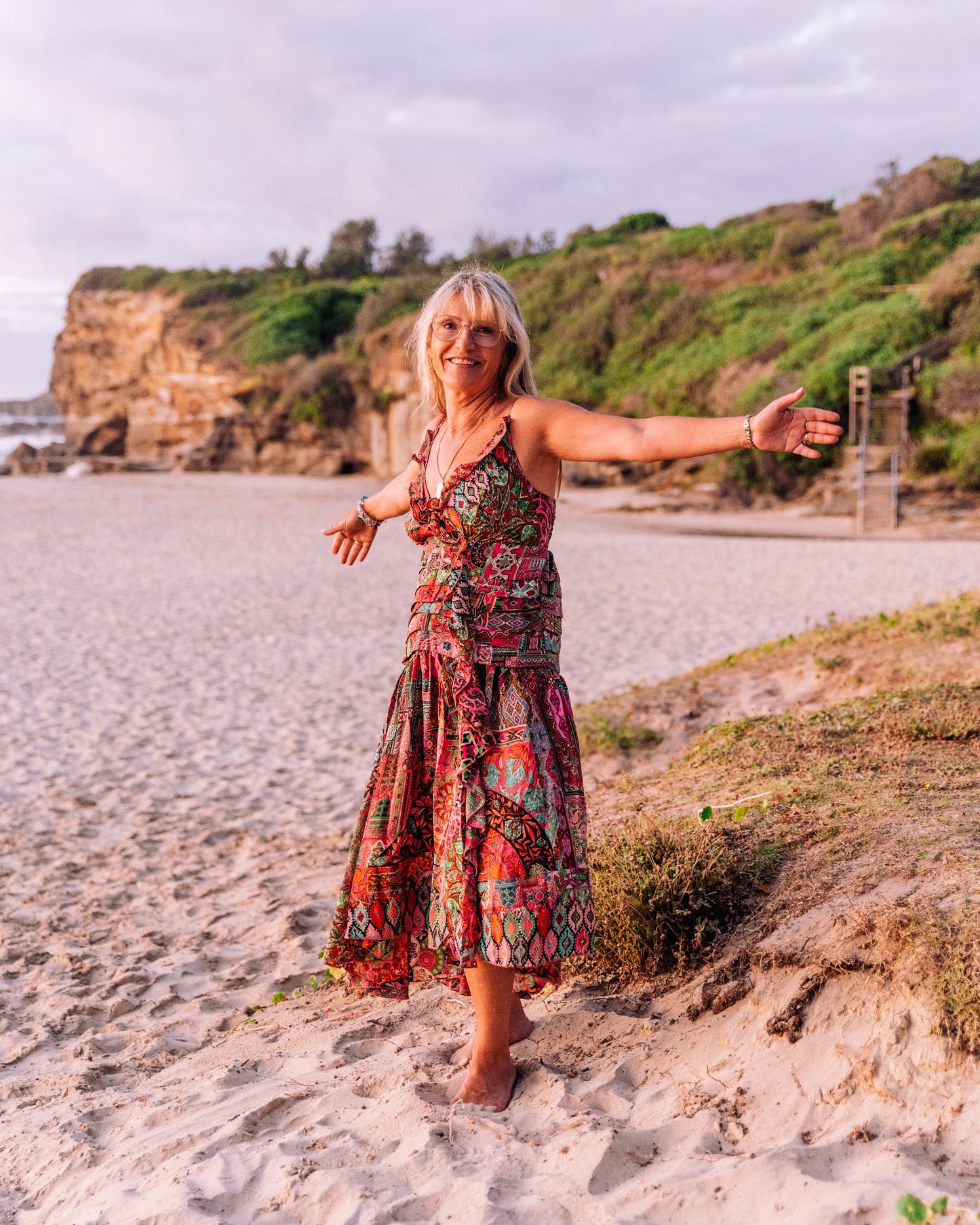 woman in the beach wearing a ruffled silk singlet maxi dress