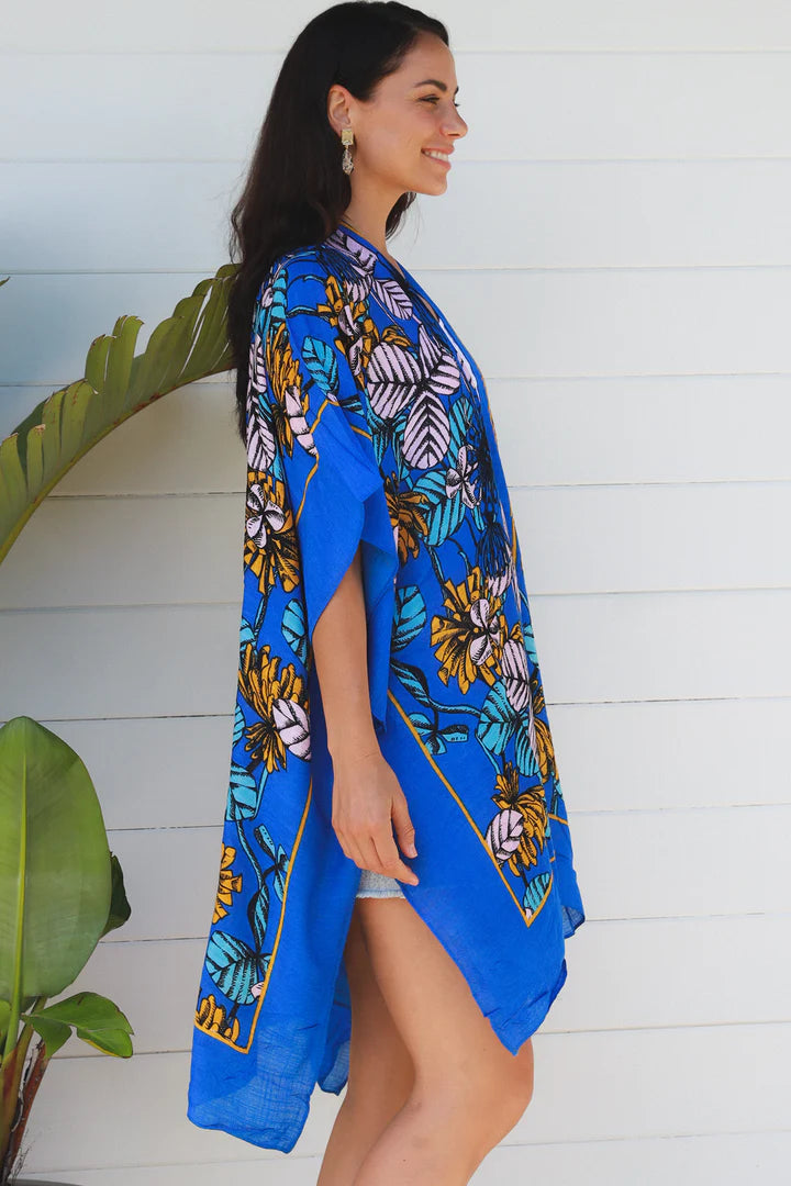woman wearing a blue tropical print kimono