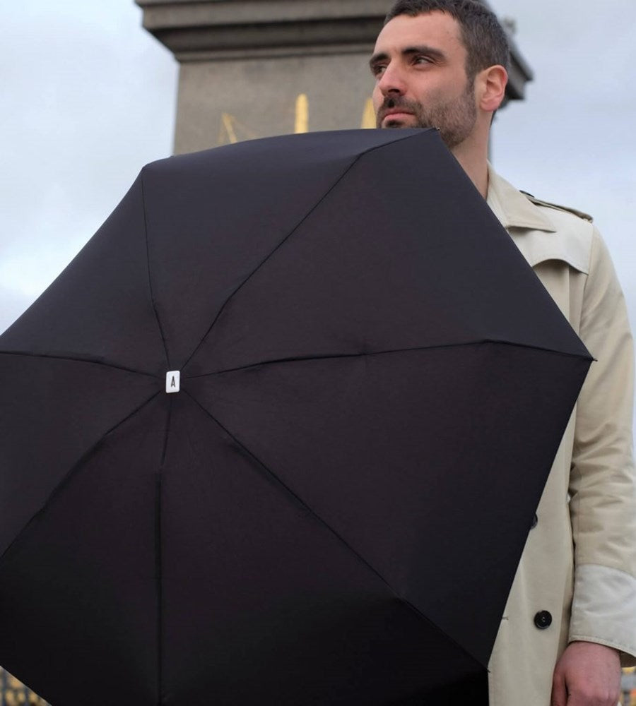 Man sporting a Anatole Jane Collapsible Micro Umbrella