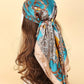 Teal and gold Bandana head scarf on a manequin head