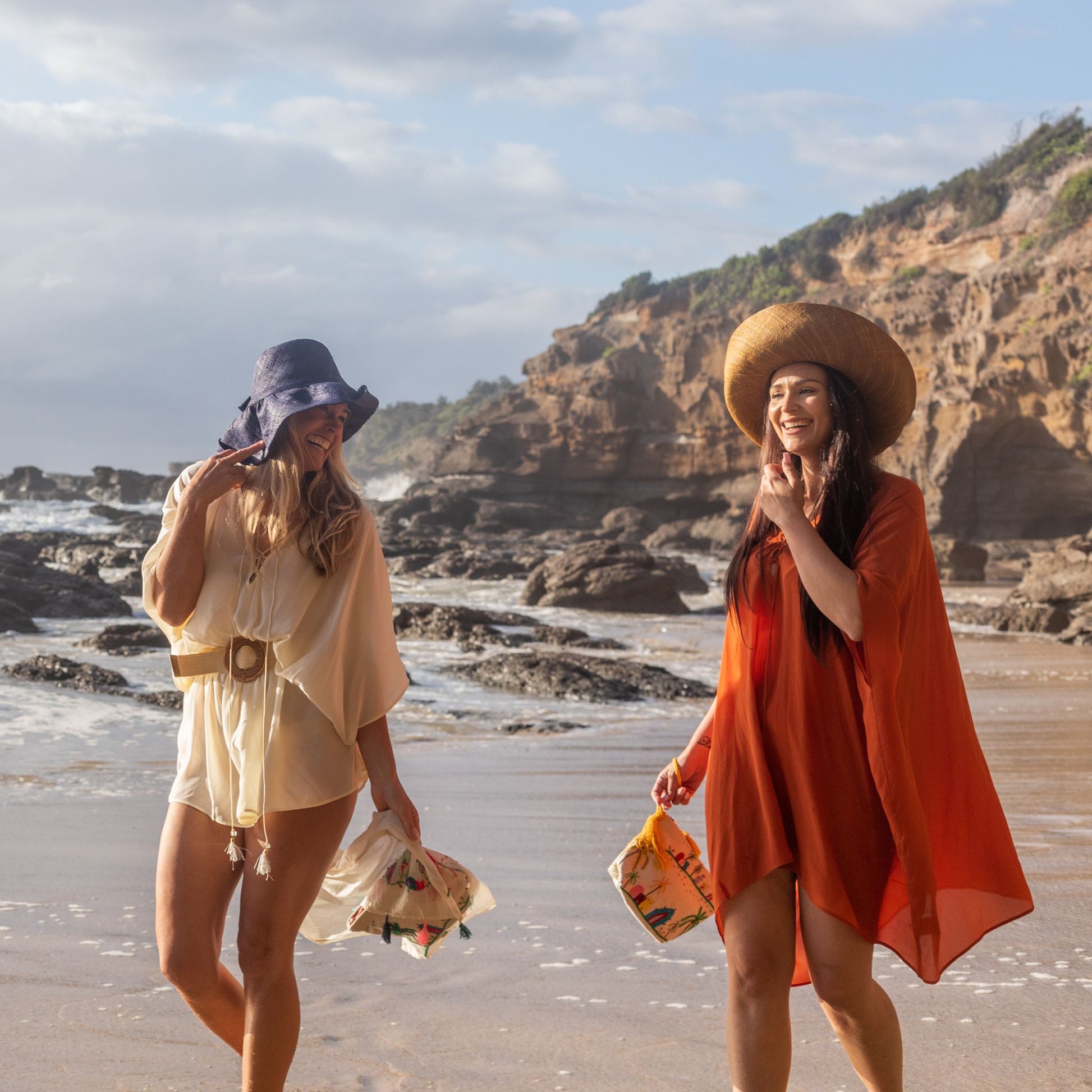 women wearing woman on the beach wearing an Amera Eid Silk Kaftans with hats