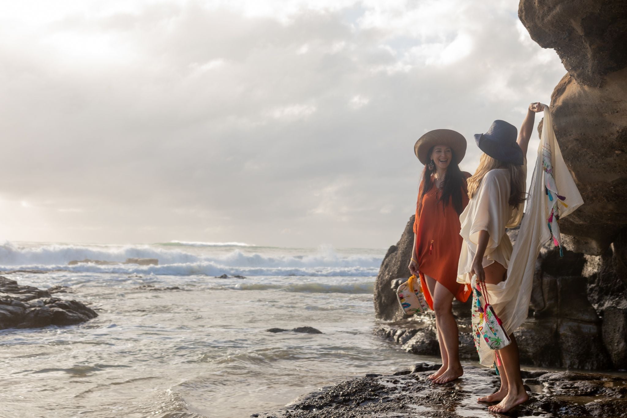 women n the beach wearing woman on the beach wearing an Amera Eid Silk Kaftans with hats