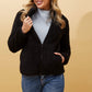 woman wearing a lynney teddy plush hooded jacket in black