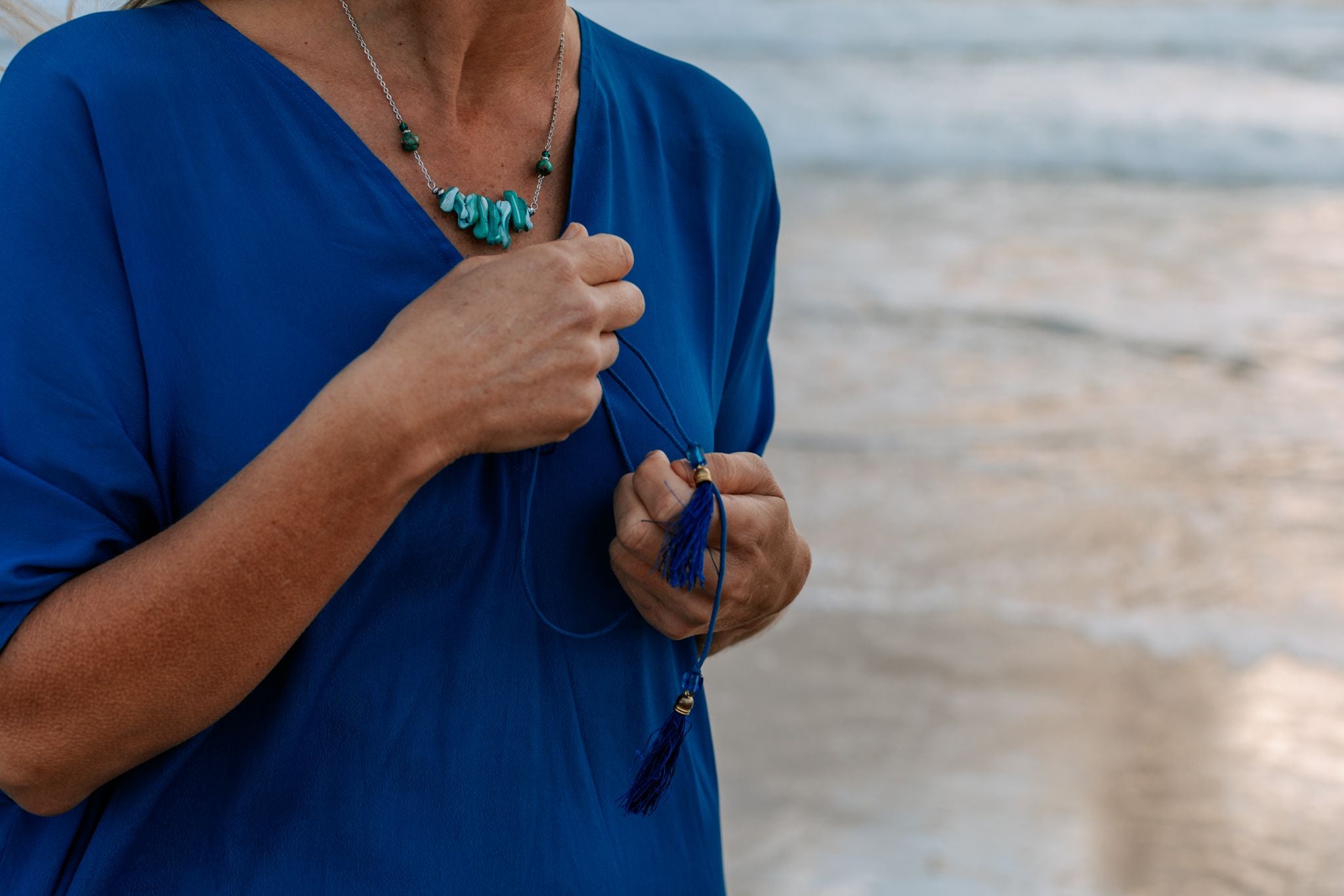 woman wearing blue woman on the beach wearing an Amera Eid Silk Kaftans