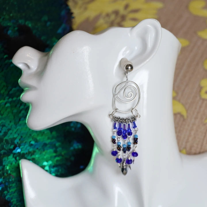 Silver River Nile Spiral Chandelier Dangling Earrings on a mannequin
