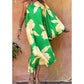 woman wearing a butterfly print green one shoulder martini midi dress