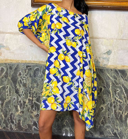 woman wearing a lemon print short poncho in blue and white zigzag pattern