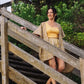 a woman walking down a wooden stairs wearing Arabesque Short & Kimono Set