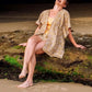 woman sitting on a rock on the beach wearing Arabesque Short & Kimono Set laughing