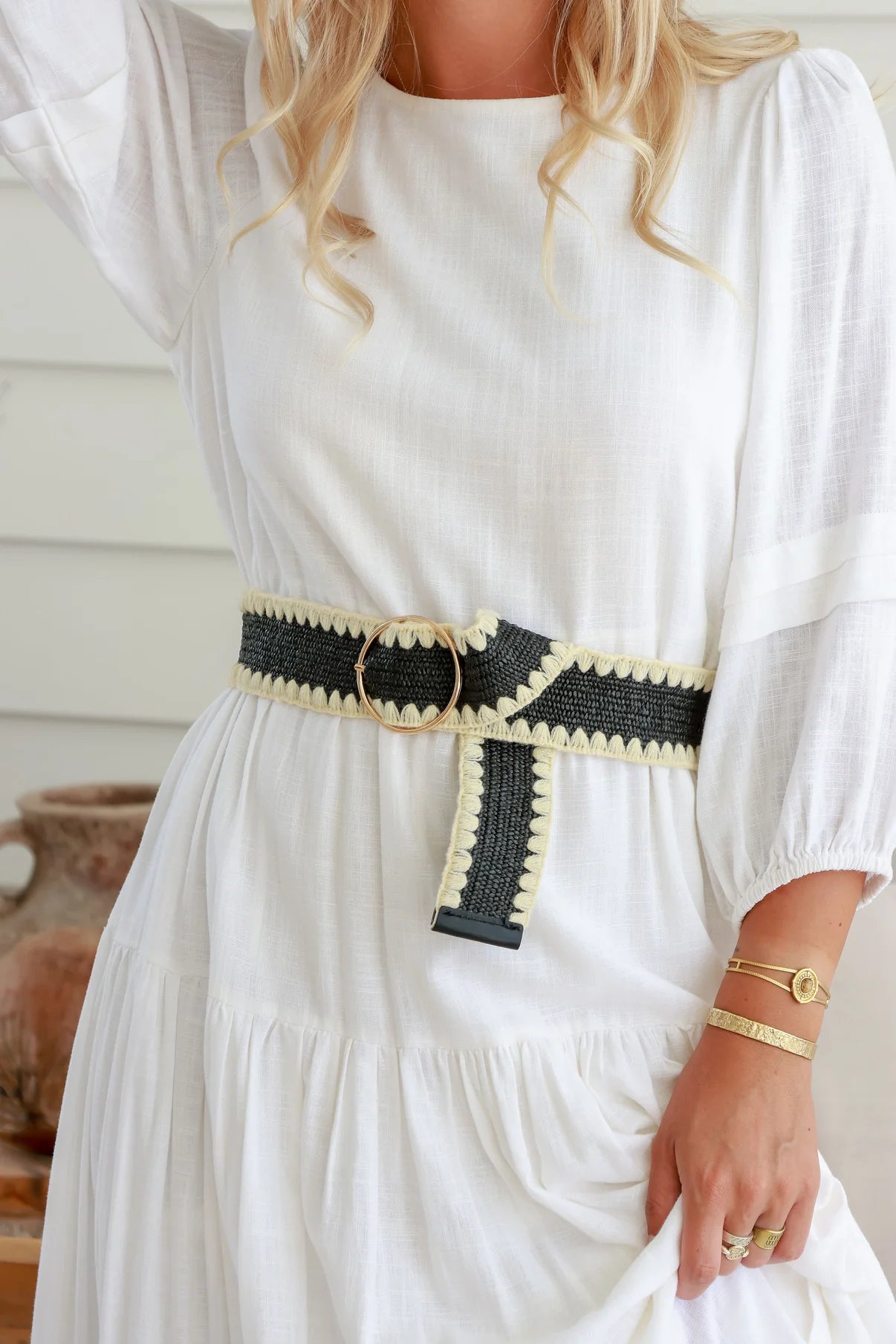 scallop edge woven belt in black and natural with gold round metal buckle