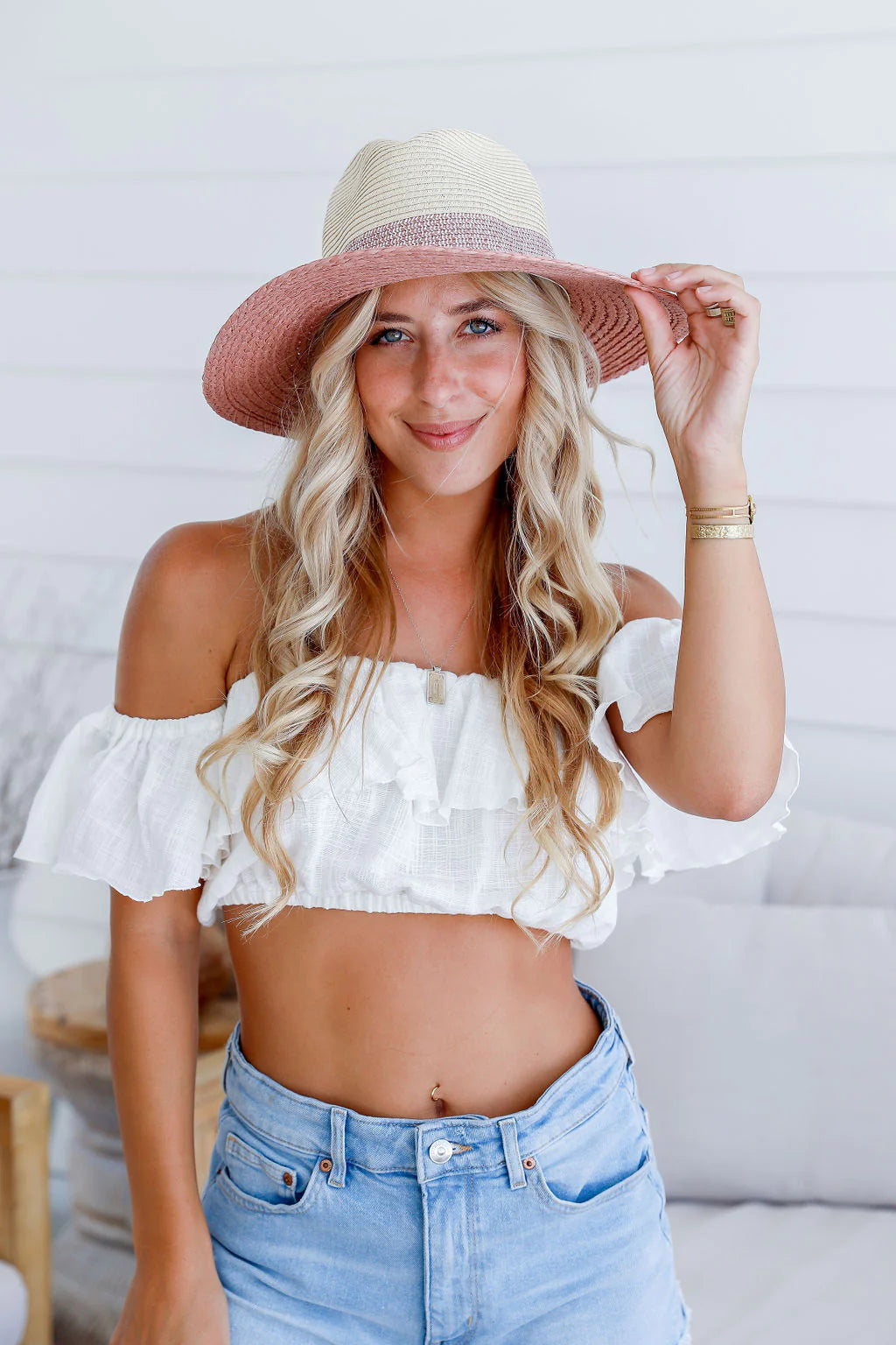 woman wearing a colored brim and band summer straw hat - blush pink