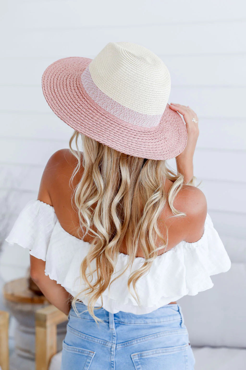 woman wearing a colored brim summer straw hat - blush pink
