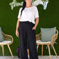 woman wearing wide shirred elastic waistband lounge pants with side pockets in black