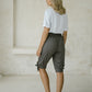 woman wearing a dark grey peace out shorts with wide smocked waistband