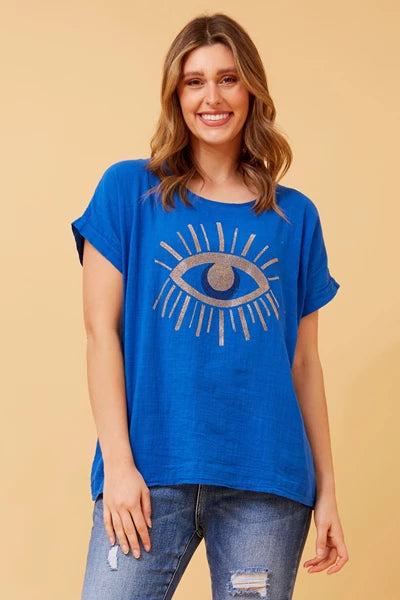 woman wearing a glittered evil eye blue top