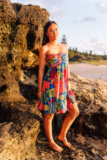 woman wearing a vibrant floral silk bandeau sundress