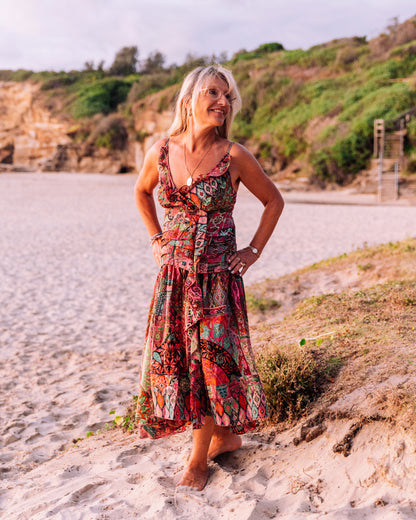 woman in the beach wearing a ruffled silk singlet maxi dress