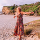 woman in the beach wearing a ruffled silk singlet maxi dress