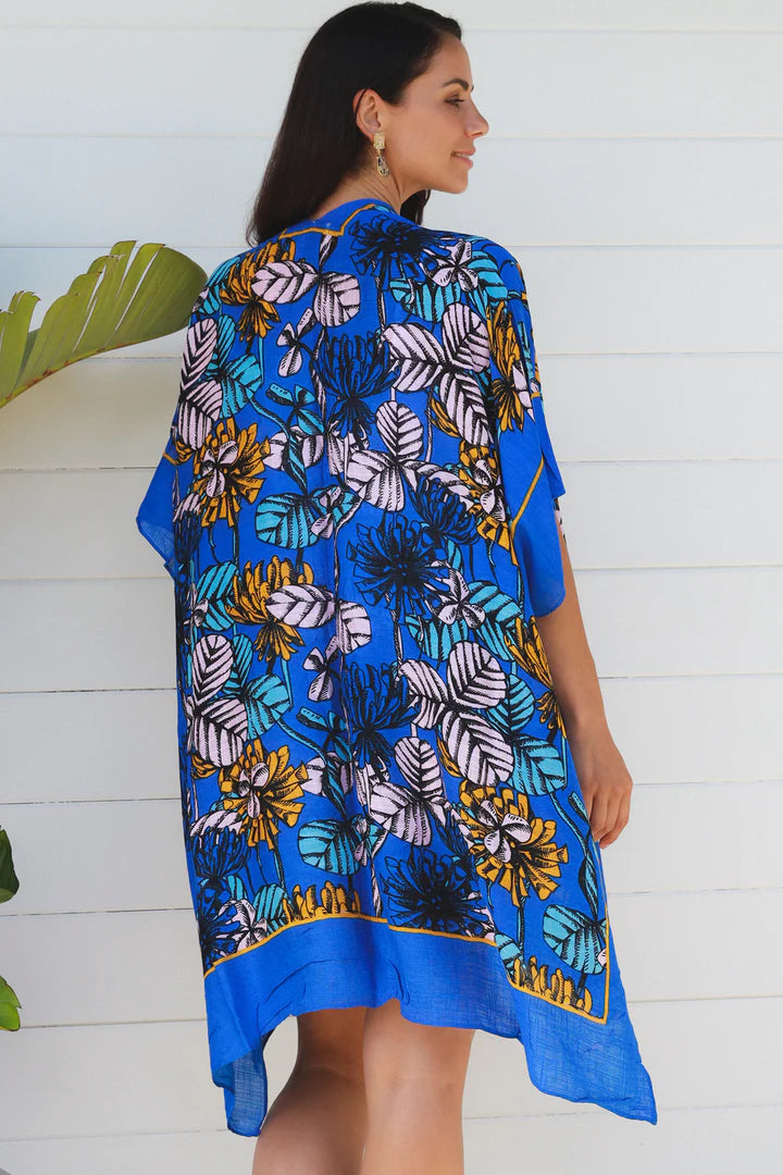woman wearing a blue tropical print kimono