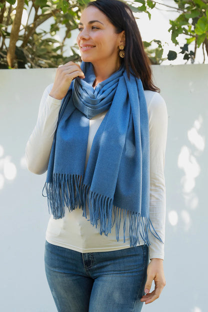 woman wearing a solid blue pashmina scarf with fringes