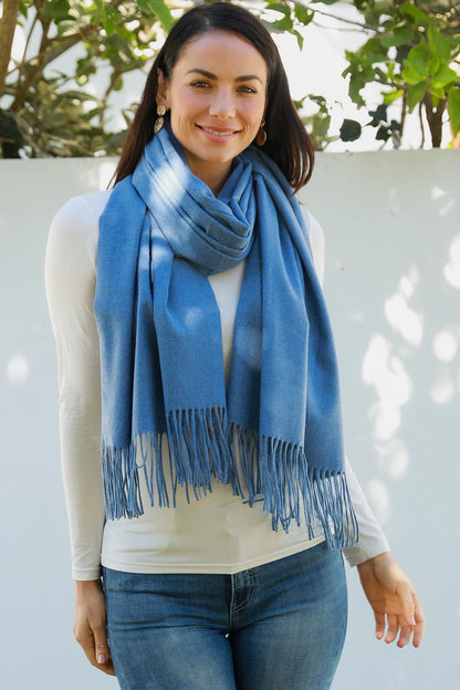 woman wearing a solid blue pashmina scarf with fringes