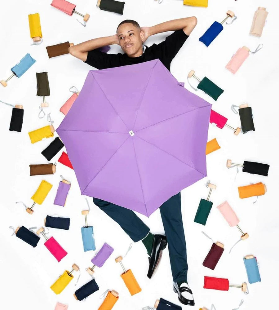 model with many Anatole Olympe Collapsible Micro Umbrella in assorted colors