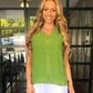 woman wearing a coconut shell button sleeveless chiffon top in olive green