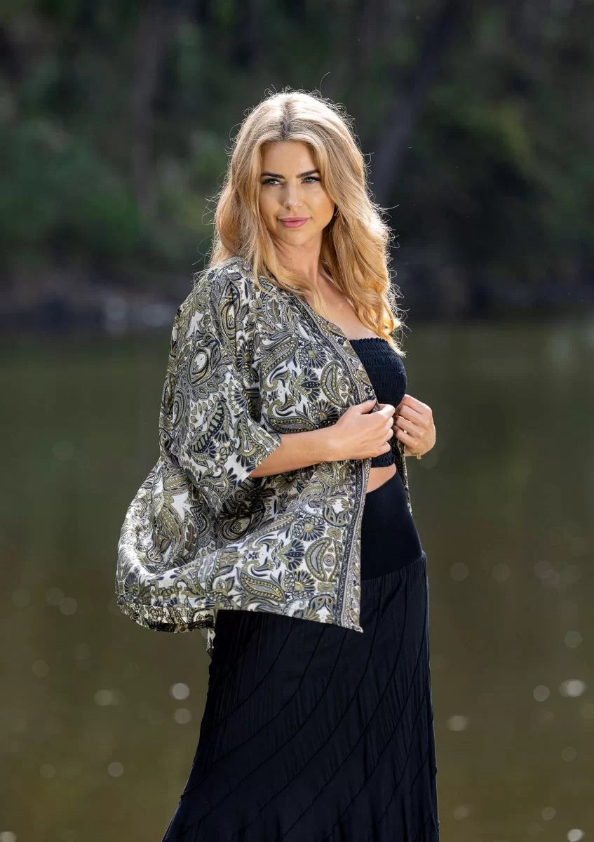woman at the lake wearing an olive paisley print kimono