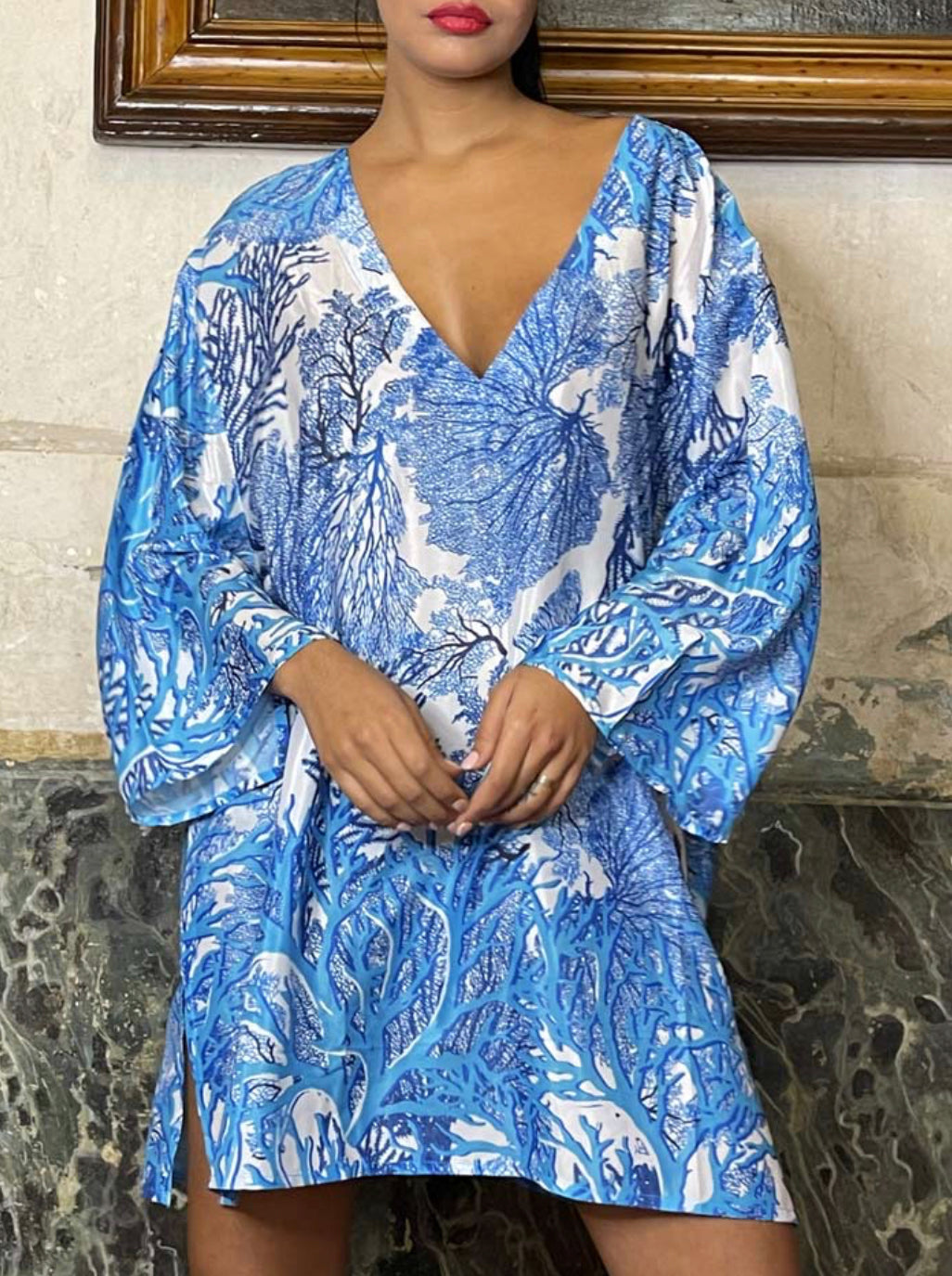 woman wearing a blue forest print deep v-neck long sleeve mini dress