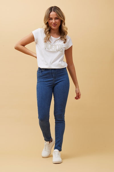 woman wearing a white top with denim pants