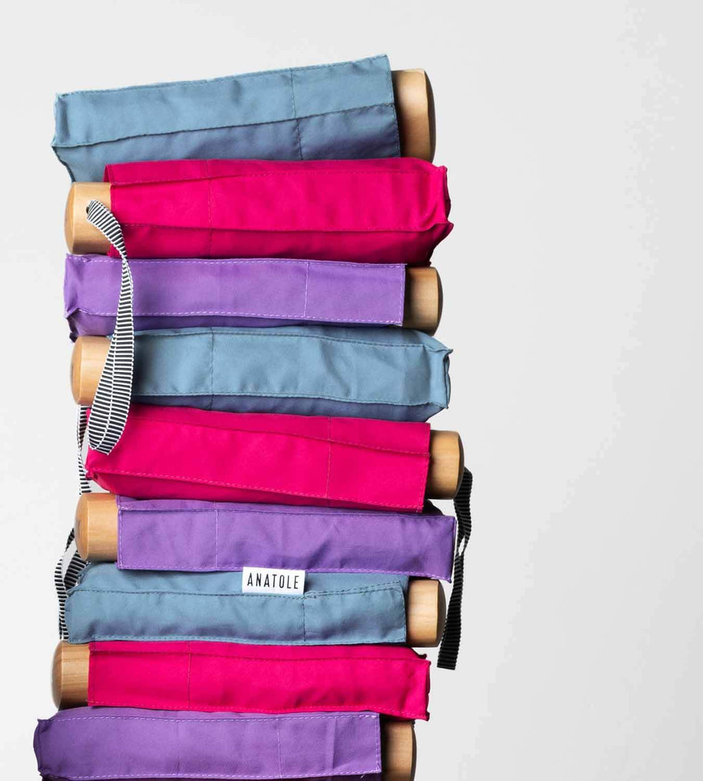 Anatole Suzanne Collapsible Micro Umbrellas stacked horizontally lying on top of each other