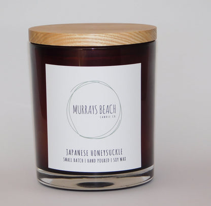 murrays beach candle co. in a glass jar with cover (japanese honeysuckle)