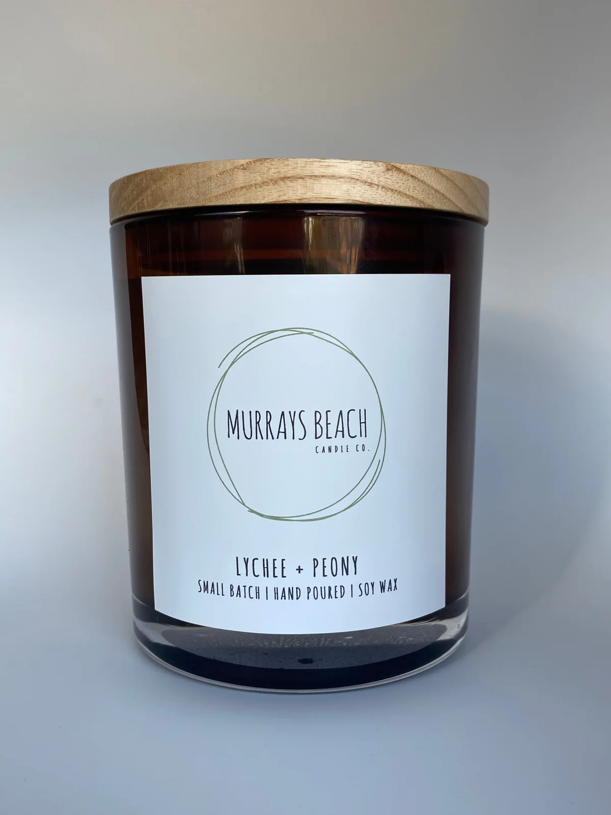 murrays beach candle co. in a glass jar with cover (lychee + peony)