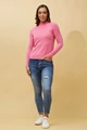 woman wearing a pink Petunia Turtleneck Long-Sleeve Knit Top