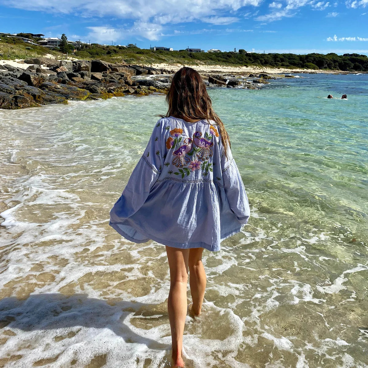 woman in the beach wearing Isla Sol Oversized Long Sleeve Sun Dress - Bird of Paradise