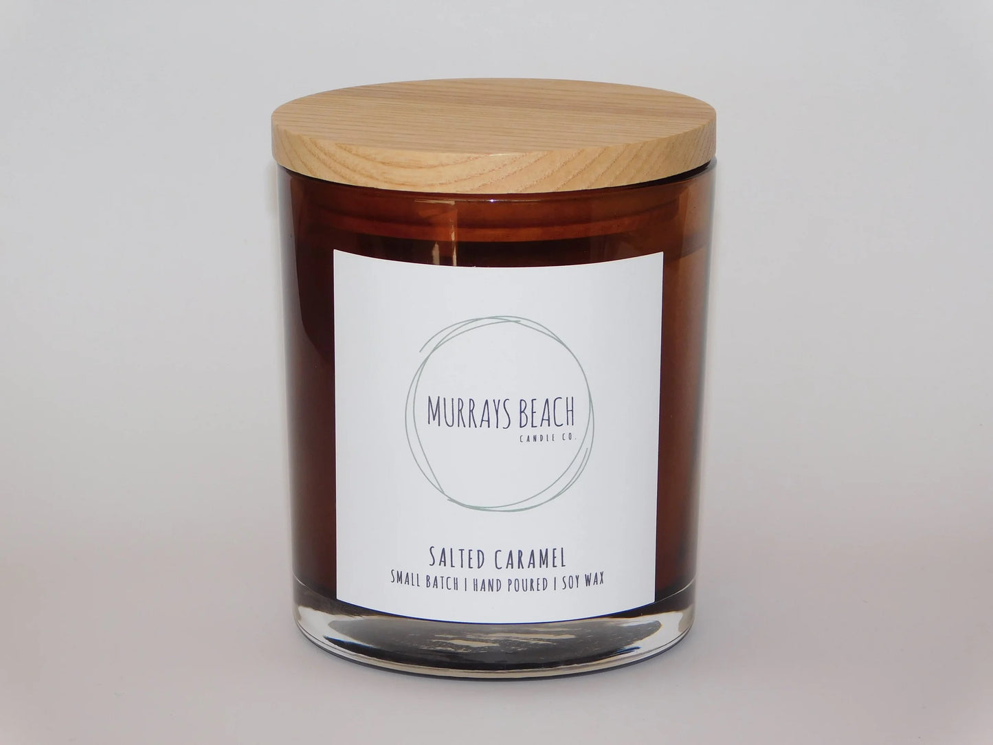 murrays beach candle co. in a glass jar with cover (salted caramel)