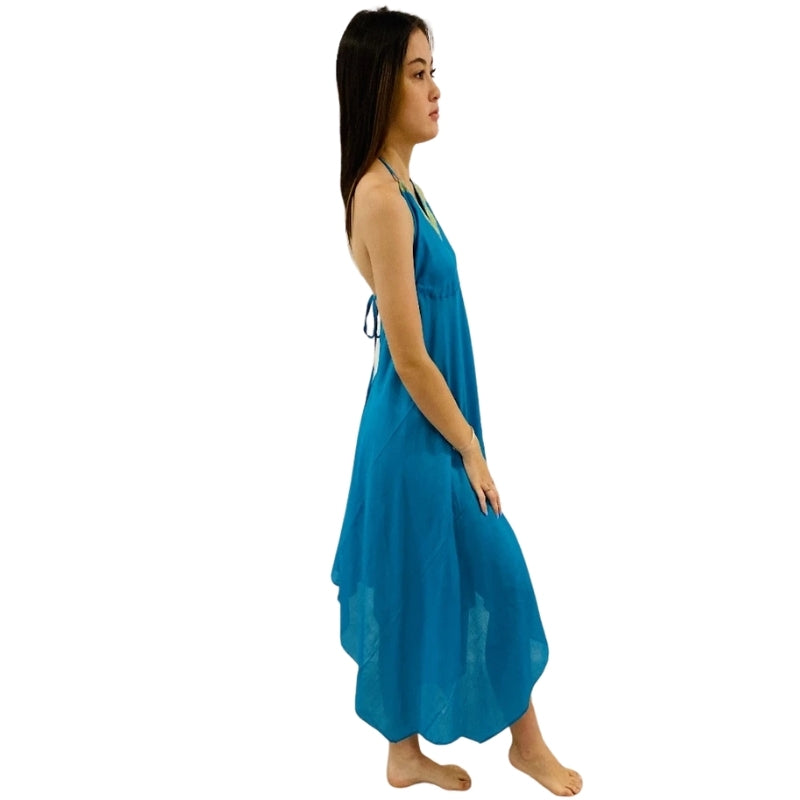 woman wearing halterneck beach dress in blue color with green lining sideview