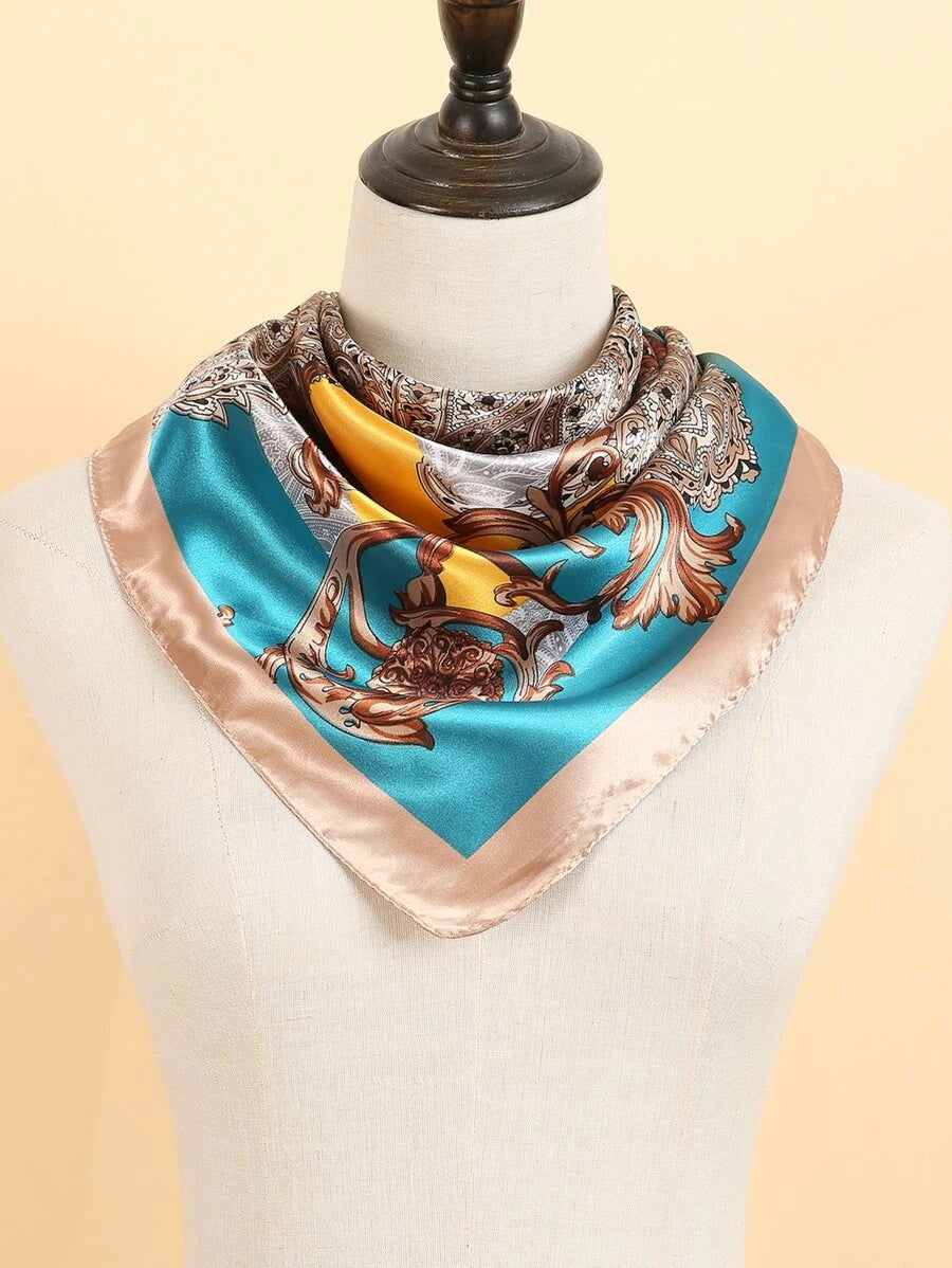 teal and gold bandana head scarf worn on a manequins neck