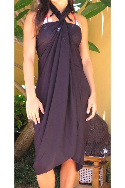 woman wearing a black plain sun-drenched sarongs beach scarf 