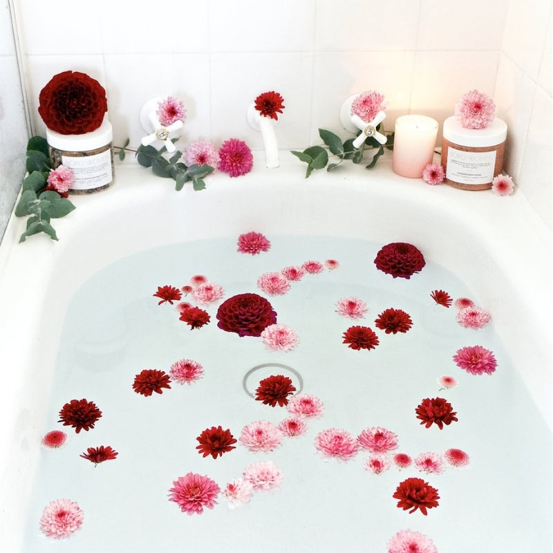 flowers in the bathtub with candles