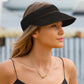 woman wearing black woven straw visor hat 