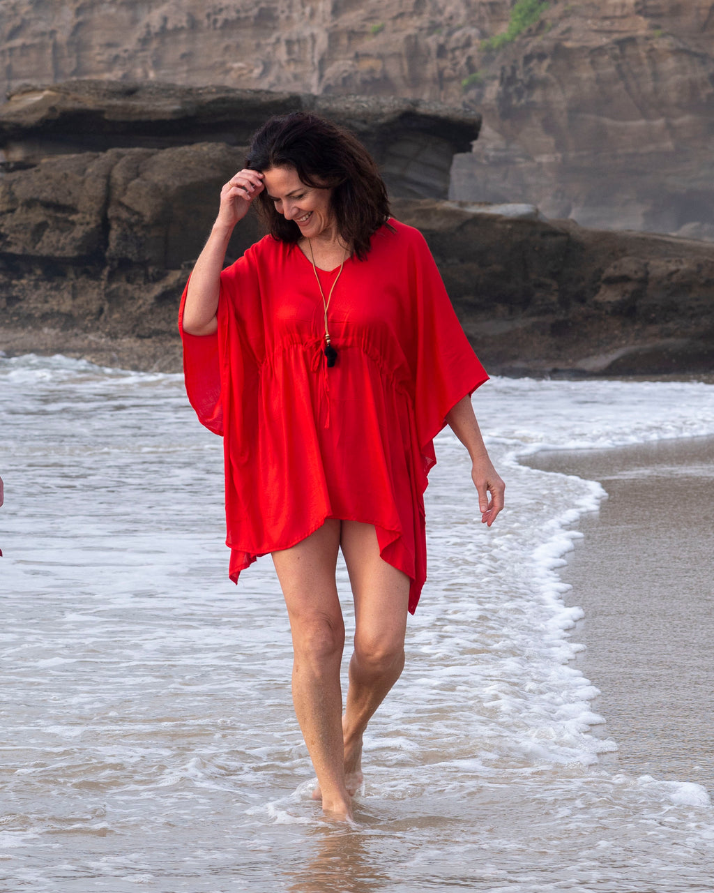 woman wearing V-Neck Beach Kaftan by Cave Woman