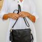 woman wearing white tiered dress with mandala cut crossbody bag with tassel in black