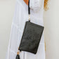woman wearing white tiered dress with mandala cut purse bag with tassel in black