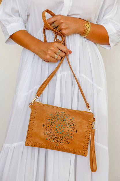 woman wearing white tiered dress with mandala cut crossbody bag with tassel in brown