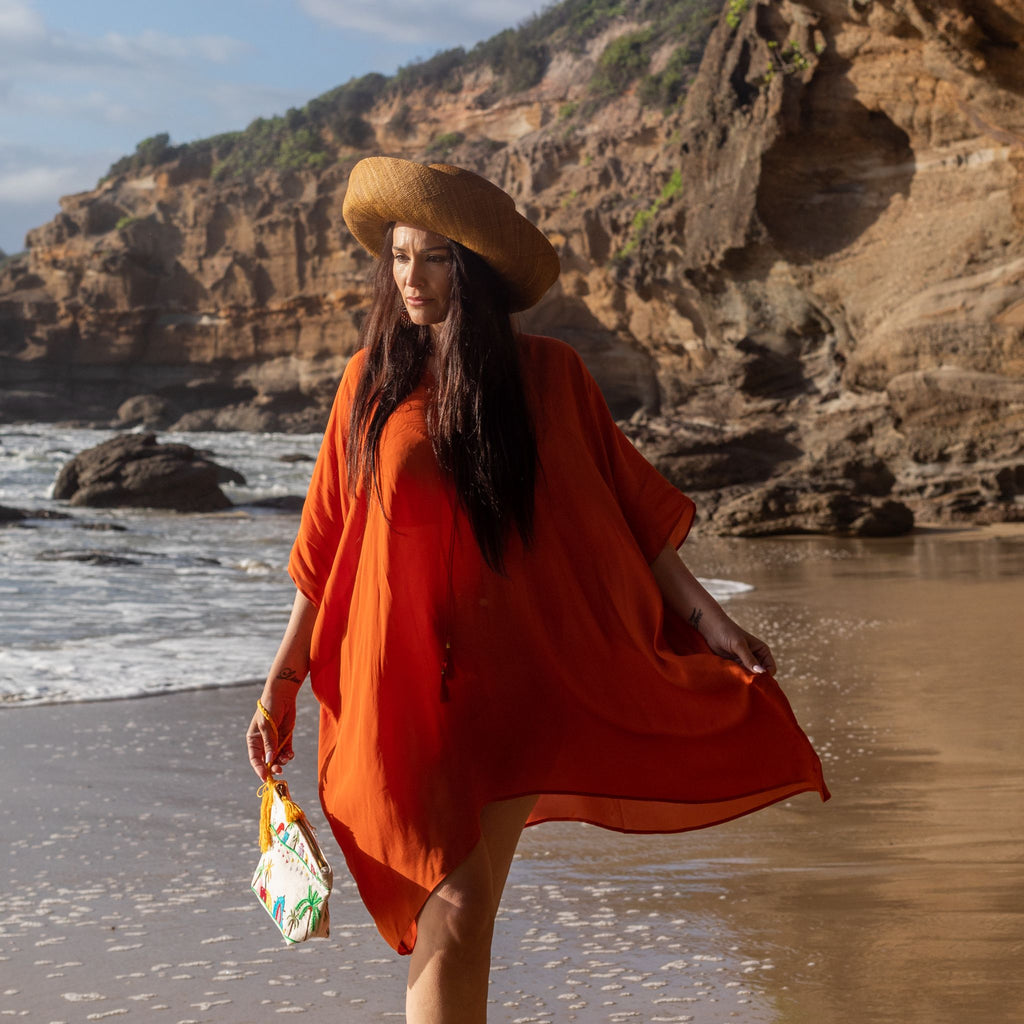 woman on the beach wearing an Amera Eid Silk Kaftans