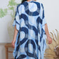 woman wearing a blue swirl kimono cover up back view