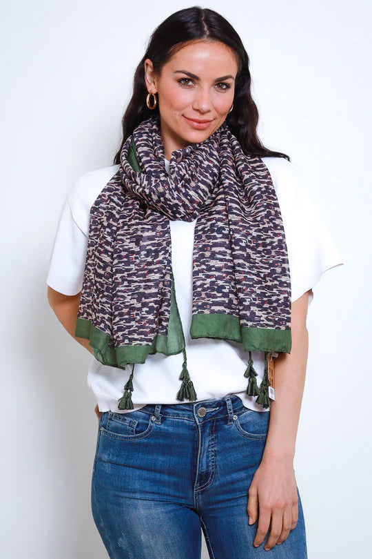 woman wearing white top with January Green Lining Leopard Print with Tassels Scarf wrapped on neck