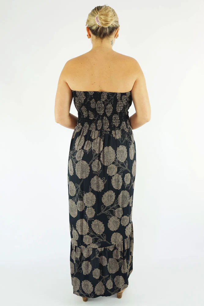woman wearing a black floral smocked strapless salsa dress back view